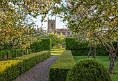 COUGHTON COURT, WARWICKSHIRE: MAY, PATH, BOX HEDGES, HEDGING, BLOSSOM, CHURCH