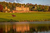 BOLESWORTH CASTLE, CHESHIRE, MAY, THE CASTLE SEEN FROM THE LAKE, SUNSET