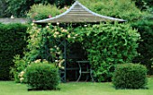 PERGOLA WITH LONICERA MUNSTER IN THE LAWN. WOLLERTON OLD HALL  SHROPSHIRE