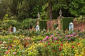 HIGHNAM COURT, GLOUCESTERSHIRE: JUNE, ROSES AND GLASS OBELISKS BY ROBERT BRYANT IN THE WINTER GARDEN TERRACE, WALL