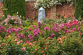 HIGHNAM COURT, GLOUCESTERSHIRE: JUNE, ROSES AND GLASS OBELISKS BY ROBERT BRYANT IN THE WINTER GARDEN TERRACE, WALL