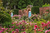HIGHNAM COURT, GLOUCESTERSHIRE: JUNE, ROSES AND GLASS OBELISKS BY ROBERT BRYANT IN THE WINTER GARDEN TERRACE, WALL