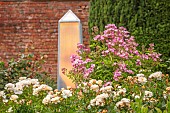 HIGHNAM COURT, GLOUCESTERSHIRE: JUNE, ROSES AND GLASS OBELISKS BY ROBERT BRYANT IN THE WINTER GARDEN TERRACE, WALL, ROSA BALLERINA