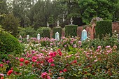 HIGHNAM COURT, GLOUCESTERSHIRE: JUNE, ROSES AND GLASS OBELISKS BY ROBERT BRYANT IN THE WINTER GARDEN TERRACE, WALL, ROSA BALLERINA