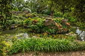HIGHNAM COURT, GLOUCESTERSHIRE: JUNE, THE FERNERY AND WATER GARDEN, ROCKERY, WATER, PULHAMITE ROCKS