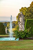 RENISHAW HALL & GARDENS, DERBYSHIRE: STATUE, SWIMMING POOL, FOUNTAIN AT DAWN, VITIS COIGNETIAE, BORROWED LANDSCAPE