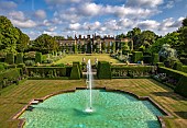 RENISHAW HALL & GARDENS, DERBYSHIRE: VIEW OF HALL FROM THE SWIMMING POOL, FOUNTAIN, YEW HEDGES, HEDGING, LAWN, JUNE