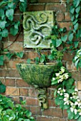 WATER FEATURE: WALL MOUNTED CERAMIC SNAKE FOUNTAIN WITH MATCHING BOWL AND BRACKET.  DESIGNER: LUCY SMITH