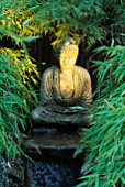 STONE BUDDHA LIT BY GARDEN & SECURITY LIGHTING IN THE NATURAL & ORIENTAL WATER GARDENS  HAMPTON COURT 97.