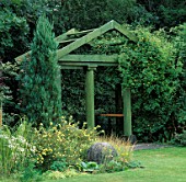 SECLUDED SEAT IN CLASSICAL STYLE WOODEN PAVILION.  BUTTERSTREAM GARDEN  IRELAND.