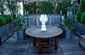 STEPHEN WOODHAMS ROOF GARDEN  LONDON. WOODEN DECKING AND TABLE WITH WHITE HEAD