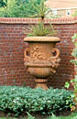 LARGE URN WITH CORDYLINE AND HEBE ALBICANS BENEATH.  MOLESHILL HOUSE  SURREY