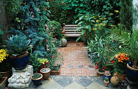 BRICK_COURTYARD_WITH_STONE_BALL__CROCOSMIA_AND_WOODEN_BENCH_IN_FOREGROUND_IS_A_TILED_FLOOR__CACTUS_A
