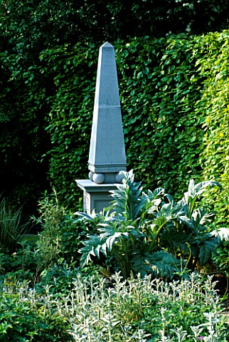 A_STONE_OBELISK_SURROUNDED_BY_CARDOONS_AND_STACHYS__ARROW_COTTAGE__HEREFORDSHIRE