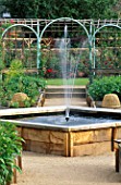 RAISED FOUNTAIN IN THE CENTRE OF  THE MEDIAEVAL HERB GARDEN. THE ABBEY HOUSE  WILTSHIRE
