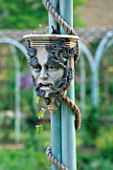 VERDIGRIS COLONNADE WITH HEAD OF THE GREEN MAN IN THE MEDIAEVAL HERB GARDEN  THE ABBEY HOUSE  WILTSHIRE