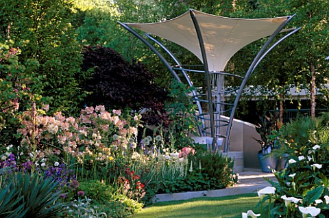 MODERN_STEEL_AND_CANVAS_CANOPY_WHICH_ACTS_AS_A_PARASOL__RAINCATCHER_AND_SOLAR_PANEL_IN_MODERN_GARDEN