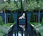 RECTANGULAR WATER CANAL WITH PLINTH AND BOAR SCULPTURE SURROUNDED BY TOPIARY YEWS AND PLATANUS ACERIFOLIA.  CHRISTIES SCULPTURE IN THE GARDEN  CHELSEA 99