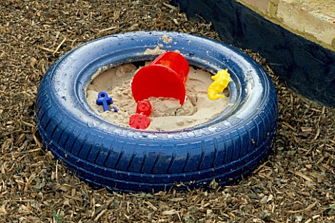 BLUE_PAINTED_TYRE_USED_AS_A_SANDPIT