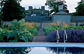 PERENNIAL PLANTING IN WALLED GARDEN BY CHRISTOPHER BRADLEY-HOLE: SWIMMING POOL WITH STEPS SURROUNDED BY DECKING AND NEPETA SIX HILLS GIANT   CYNARA CARDUNCULUS AND STIPA GIGANTEA