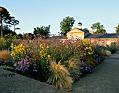 PERENNIAL PLANTING IN WALLED GARDEN BY CHRISTOPHER BRADLEY-HOLE: VERBENA BONARIENSIS  STIPA TENUISSIMA  ASTER X FRIKARTII MONCH AND HELIANTHUS MORNING SUN