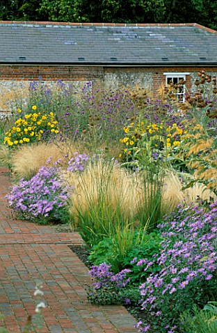 PERENNIAL_PLANTING_IN_WALLED_GARDEN__BY_CHRISTOPHER_BRADLEYHOLE_STIPA_TENUISSIMA__ASTER_X_FRIKARTII_