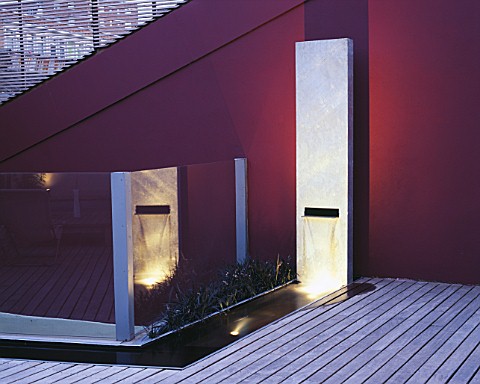 ROOF_GARDEN_WITH_LIGHTING_TIMBER_DECKING__RENDERED_WALL_PAINTED_AUBERGINE__WATER_FEATURE_MADE_FROM_G