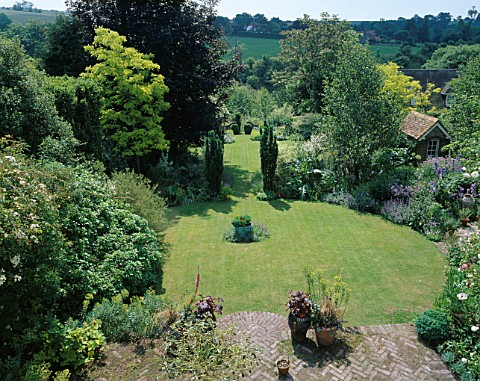 LONG_SHOT_OF_THE_GARDEN_FROM_THE_HOUSE_WITH_4_TAXUS_BACCATA_FASTIGIATA__TWO_CIRCULAR_LAWNS__SHED_AND