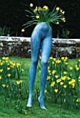 SURREALIST INSPIRED IMAGE OF MANNEQUIN LEGS PLANTED   AND SURROUNDED BY NARRCISSI. DESIGNED BY IVAN HICKS. GROOMBRIDGE PLACE  KENT.