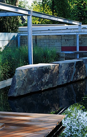 METAL_GIRDERS__NATURAL_ROCK__DECKING_AND_MISCANTHUS_IN_MODERN_WATER_GARDEN_THE_DAILY_TELEGRAPHRF_HOT