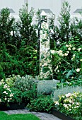 MIRRORED OBELISK STANDS IN MIXED WHITE BORDER WITH ROSA  LILIUM AND DIGITALIS. HOMES & GARDENS THE GARDEN OF REFLECTION DESIGNED BY A. ARMOUR WILSON & P. ROGERS. CHELSEA 2000