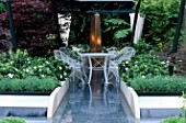 FLOOR OF POLISHED BLUE GRANITE LEADS TO WHITE GARDEN FURNITURE & BRONZE WATER FEATURE. SHAIKH ZAYED BIN SULTAN AL-NAHYANS THE GARDEN OF THE NIGHT. CHELSEA 2000