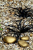 GRAVEL WITH OPHIOPOGON NIGRESCENS AND GOLD PAINTED PEBBLES. DESIGNER: CLARE MATTHEWS