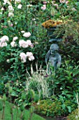 CAROLYN HUBBLES SHROPSHIRE GARDEN : BRONZE STATUE BESIDE ENGLISH ROSE REDOUTE