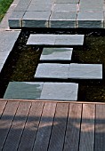 WATER FEATURE:  SHOWING  STEPPING STONES OVER WATER WITH DECKING.  DESIGNER JOE SWIFT.