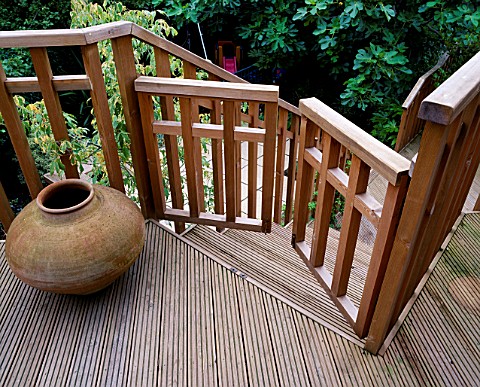 DECKED_TERRACE_AND_BALCONY_WITH_CHILD_SAFE_GATE_AND_TERRACOTTA_URN_DESIGNER__SARAH_LAYTON