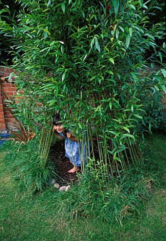 NANCY_PLAYING_IN_THE_LIVING_WILLOW_WIGWAM_IN_THE_CHILDRENS_GARDEN_DESIGNER_CLARE_MATTHEWS