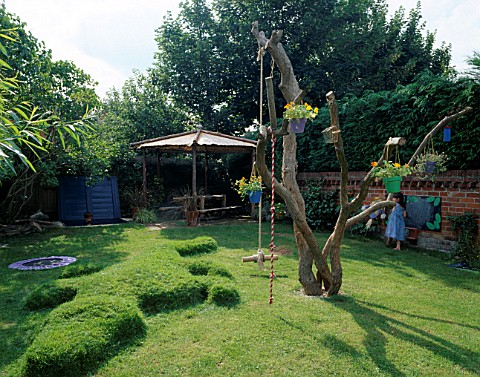 THE_CHILDRENS_GARDEN_WITH_DEAD_TREE__TURF_CROCODILE__TRAMPOLINE__SANDPIT__BLACKBOARD__DIPPING_POND_A
