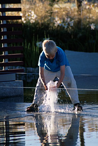 ROBERT_PLAYS_IN_FOUNTAIN_IN_MINIMALIST_WATER_GARDEN_DESIGNED_BY_ULF_NORDFJELL_HEDENS_LUSTGARD__SWEDE