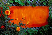 PATIO GARDEN: LILAC TRELLIS WITH  ABSTRACT ORANGE PAINTING BY CLIVE NICHOLS  DAHLIAS BISHOP OF LLANDAF AND DAVID HOWARD