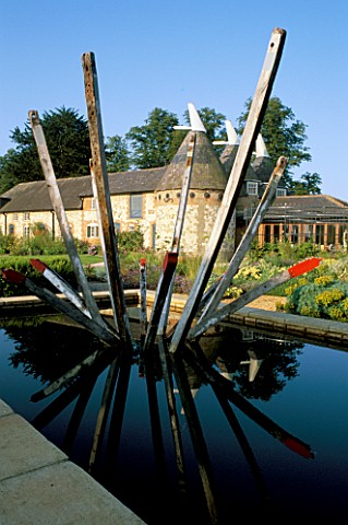 RECTANGULAR_POND_WITH_WOODEN_SCULPTURE_BY_PAUL_ANDERSON_BURY_COURT__HAMPSHIRE