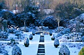 EASTLEACH HOUSE  GLOUCESTERSHIRE: THE RILL GARDEN COVERED IN SNOW WITH THUJA ORIENTALIS AUREA NANA AND SORBUS ARIA LUTESCENS