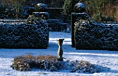 THE WALLED GARDEN COVERED IN SNOW. EASTLEACH HOUSE  GLOUCESTERSHIRE: SUNDIAL AND YEW HEDGING