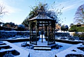 EASTLEACH HOUSE GARDEN  GLOUCESTERSHIRE: THE BANDSTAND IN THE WALLED GARDEN COVERED WITH SNOW