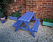 GRAVEL TERRACE WITH BLUE WOODEN CHILDRENS BENCH