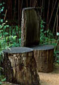 WOODEN SEATS IN VARIOUS SHAPES IN A CLEARING IN THE WOODS AT CHAUMONT-SUR-LOIRE: DESIGN BY JEAN LAUTREY
