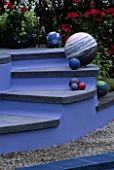 GRAVEL GARDEN WITH BLUE CONCRETE STEPS AND CONCRETE SPHERES: DESIGNER: CAROLE VINCENT