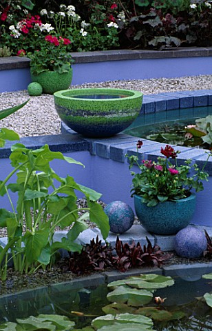 BLUE_CONCRETE_POND_SET_IN_GRAVEL_AND_PLANTED_WITH_WATERLILIES__DESIGNER_CAROLE_VINCENT