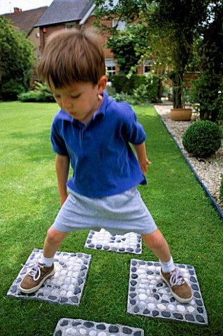 WILLIAM_PLAYS_ON_THE_HOPSCOTCH_SLABS_MADE_WITH_CEMENT_AND_WHITE_AND_BLACK_PEBBLES