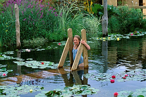 CHARLIE_ELLIS_AGE_10_IN_THE_SWIMMING_POND__DESIGNED_BY_DANIEL_LLOYDMORGAN_FOR_CAPEL_MANOR